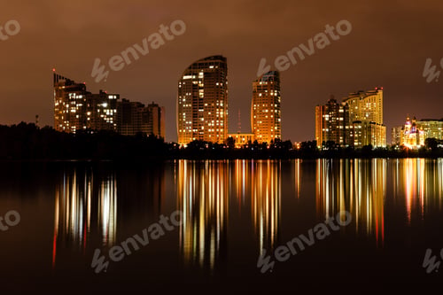 Preview: night city with reflection of houses in the river