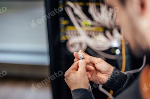 Preview: Technician inspecting ethernet jack, at data center.