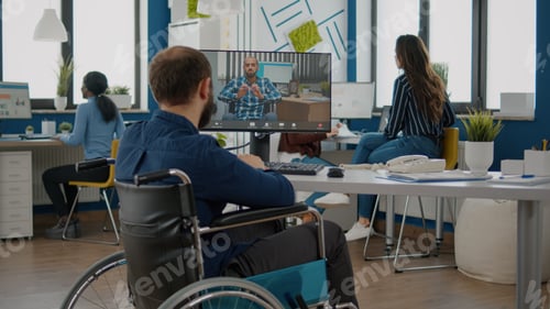 Preview: Immobilized freelancer talking on videocall with remote colleague