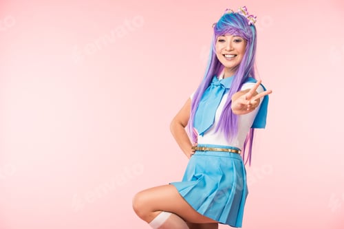 Preview: Happy asian anime girl standing on one leg and showing peace sign on pink