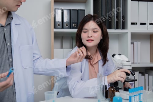 Preview: Lab Technician Discussing Findings With Colleague Over Sample
