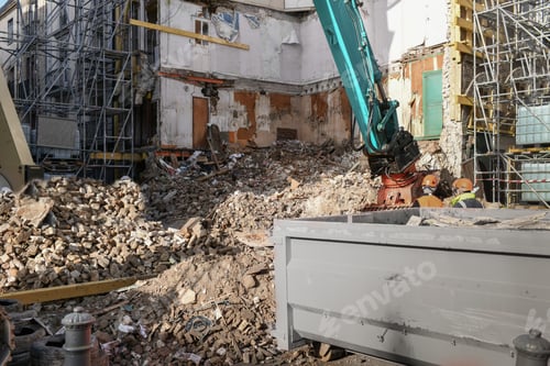 Preview: Ruined destroyed house. An excavator destroys a house with a bucket.