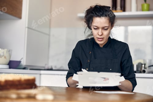 Preview: Woman Packing Cake in Kitchen for Delivery