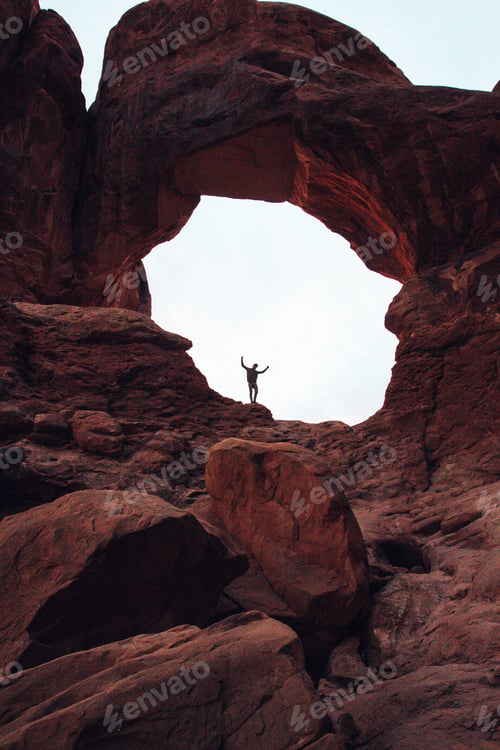 Preview: Man arms up in red stone arch