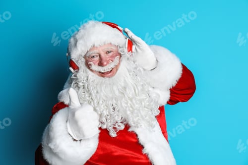 Preview: Authentic Santa Claus listening to music on color background