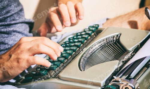 Preview: Man hands typing on a vintage typewriter.