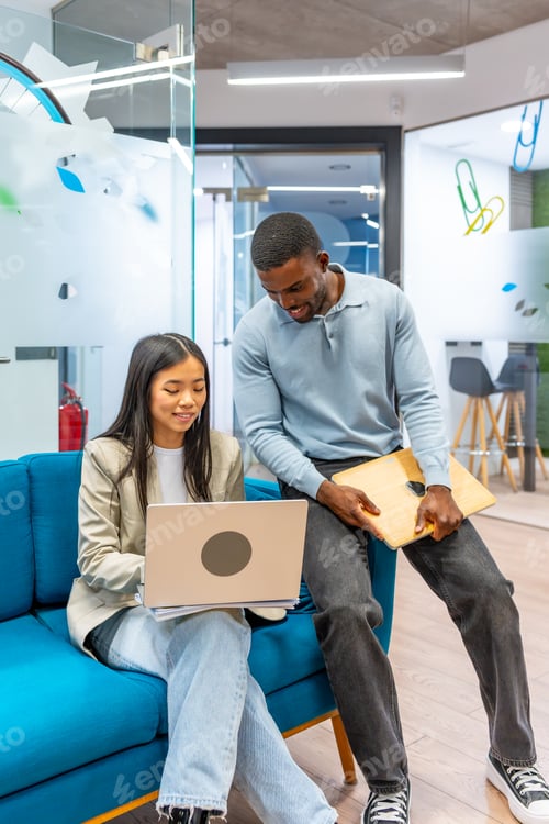 Preview: Coworkers collaborating on project in modern office space