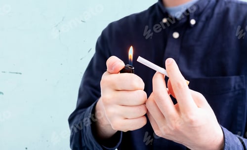 Preview: a person holding a spark lighter flame and a cigarette, smoking bad habbit