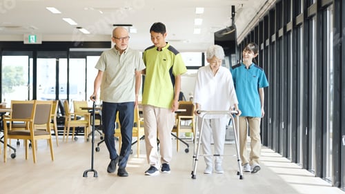Preview: Asian caregiver supporting elderly people walking