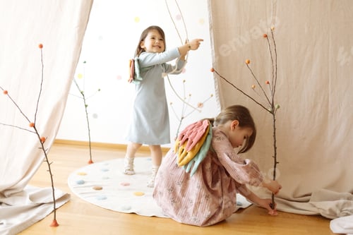 Preview: Two Young Girls Playing with Branches Indoors