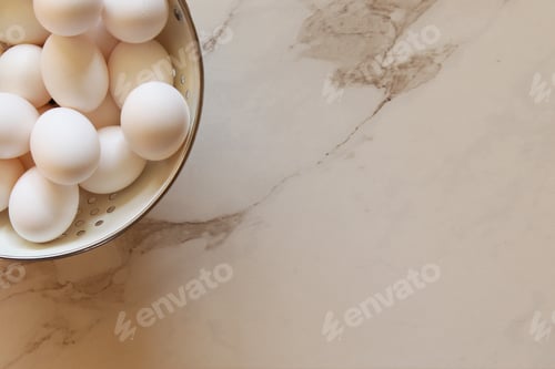 Preview: Eggs in strainer with marble copy space