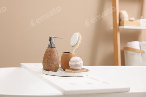 Preview: Different personal care products and accessories on bath tub in bathroom