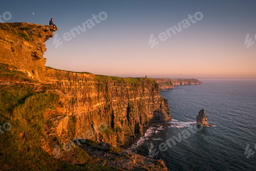 Preview: Lone figure atop the majestic cliffs at sunset