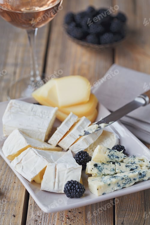 Preview: Cheese plate. Assortment of cheese with berries and glass of rose wine