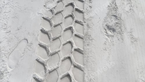 Preview: Wheel track and footprints on the sand