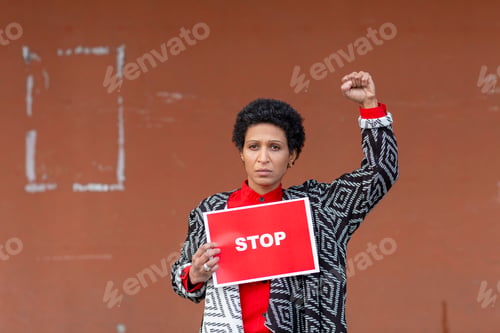 Preview: Italy, Tuscany, Pistoia, Woman holding stop sign and raising fist