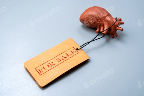Preview: A model of a human heart with a for sale tag.
