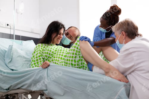 Preview: Multi ethnic obstetrics specialists delivering child