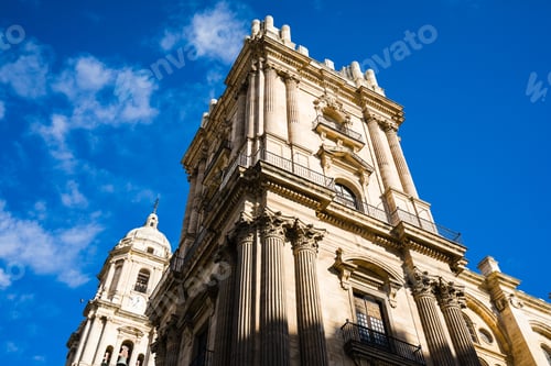Preview: Low angle shot of the ancient Malaga cathedral on the blue sky background, Spain