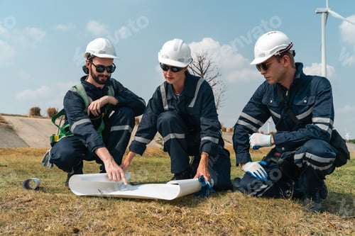 Preview: Wind turbine engineer team reviewing energy project blueprint for sustainability and clean energy