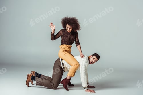Preview: african american retro styled girl sitting on boyfriends back and having fun