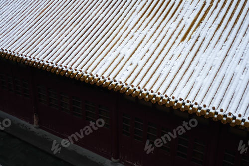 Preview: Close-up view of a roof covered in snow, with roof tiles visible beneath