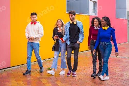 Preview: Group of multi-ethnic friends walking on university campus having fun, young millennials mobile