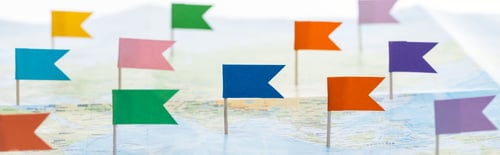 Preview: panoramic shot of colorful flag pins on world map