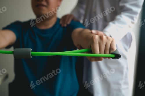 Preview: Asian male physical therapist descent working with patient doing stretching exercise