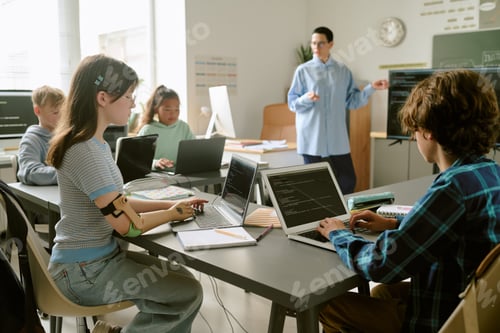 Preview: Diverse Teenagers Collaborating on Coding Project in Classroom Setting