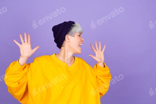 Preview: Stylish european woman on purple background happy positive dancing moving