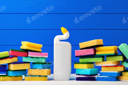 Preview: Stack of new cleaning sponges and liquid detergent against blue wooden background