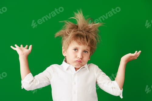 Preview: Surprised child against green chalkboard in class