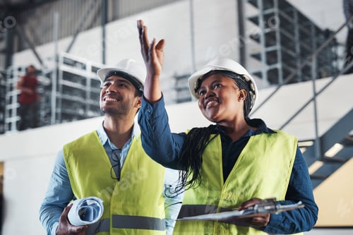 Preview: Shot of two young contractors standing together in the warehouse and observing the layout