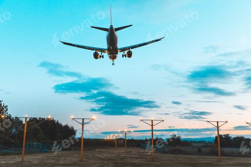 Preview: Airplane silhouette landing at the airport dusk