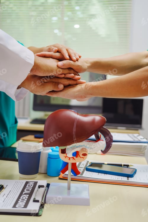 Preview: Three doctors join hands at a hospital table after meeting on liver disease,discussing conditions