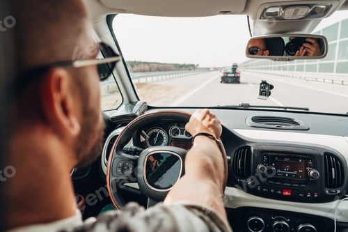 Preview: The man in the car traveling on the road