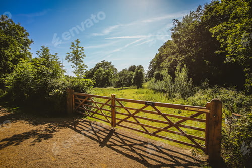 Preview: Closeup of a wooden fence gate at the farm in the summer countryside