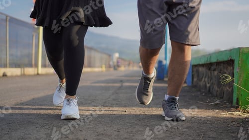 Preview: Close up side view photo of young asian couple legs running