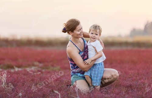Preview: Young woman and her son having fun outdoors