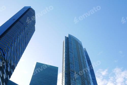 Preview: low angle view of singapore city financial buildings against blue sky