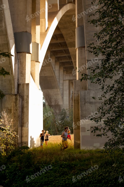 Preview: Joggers running under arch bridge, Arroyo Seco Park, Pasadena, California, USA
