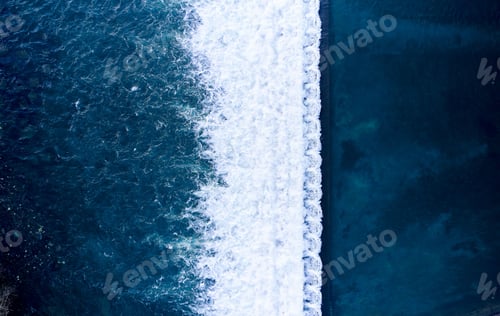 Preview: Top view of a blue wavy seascape, creating white foams