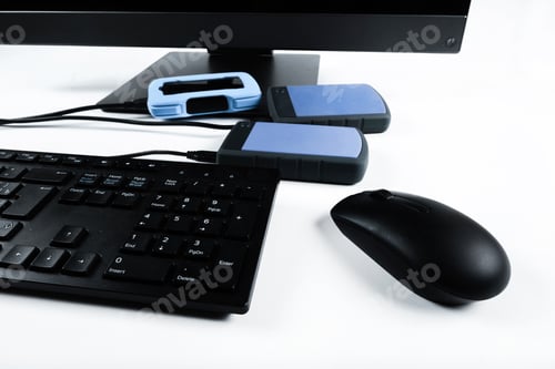 Preview: Multiple external hard drives connected to a monoblock on a white background.Computer with hard