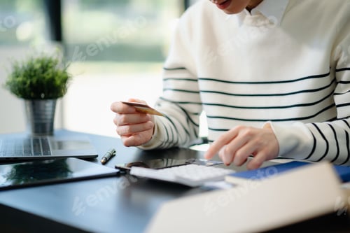Preview: Financial owe, hand of asian man sitting, holding credit card, stressed by calculate expense