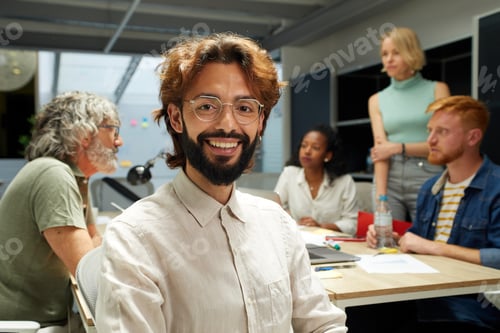 Preview: Portrait of a smiling man posing looking at the camera at the office.