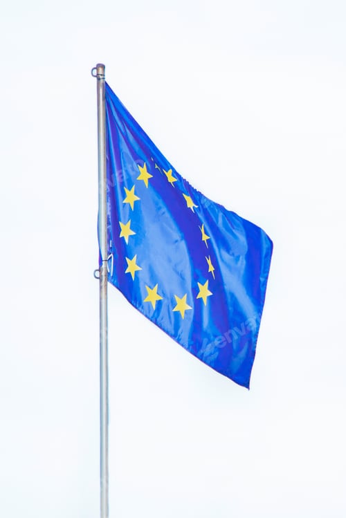 Preview: flag of the European Union, develops in the wind on a flagpole, isolated on a white