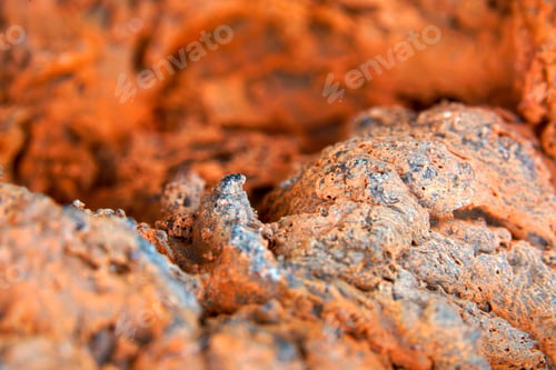 Preview: Closeup shot of orange solidified volcanic rock texture in daylight