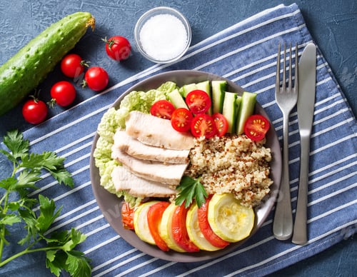 Preview: Healthy vegetable buddha bowl lunch with turkey, vegetables and quinoa on blue background. Top view.