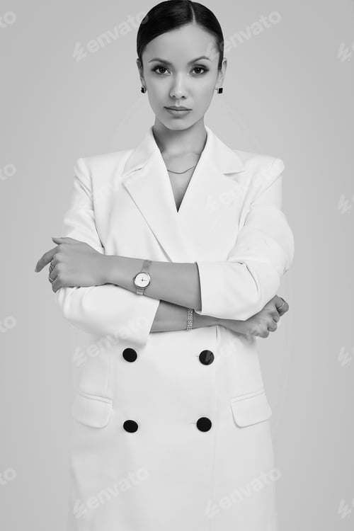 Preview: Portrait Of A Cute And Gorgeous Latin Women In Fashion White Suit Posing On Bright Studio Background
